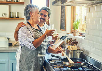 Image showing Toast, wine and senior couple at stove cooking healthy food together in kitchen with smile, health and romance. Cheers, drinks and old woman with man, glass and happiness, meal in pan and retirement.