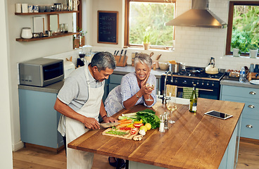 Image showing Cooking, happiness and old couple with wine at kitchen counter, healthy food and marriage bonding in home. Drink, glass and vegetables, senior woman and man with vegetable meal prep and retirement.