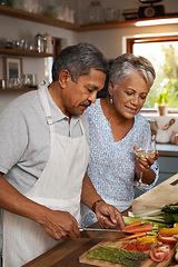 Image showing Vegetables, cooking and old couple with wine in kitchen, healthy food and marriage time together in home for dinner. Drink, glass and senior woman with man, meal prep and wellness diet in retirement.