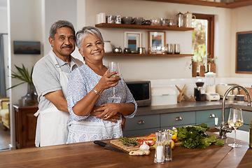 Image showing Portrait of old couple at kitchen counter with wine, embrace and cooking healthy vegetable dinner together. Smile, happiness and food, senior man and happy woman with drink, vegetables and retirement