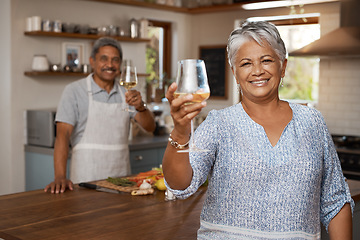 Image showing Cheers, wine and portrait of old couple in kitchen cooking healthy food together in home with smile. Toast, drinks and senior woman with man, glass raised and happiness, diet meal prep and retirement
