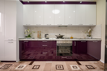 Image showing Purple and white modern kitchen furniture, front view