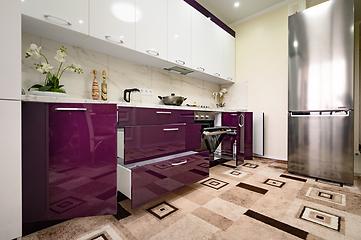 Image showing Purple and white modern kitchen furniture, front view