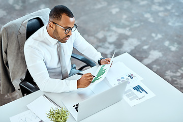 Image showing Financial analyst, focus and black businessman planning in an office or reading report and employee on desk. Serious, corporate worker and graphs or revenue documents or laptop and stats data at work