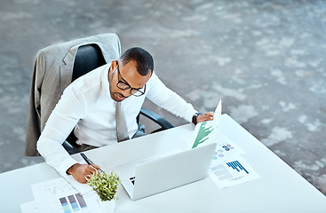 Image showing Financial analyst, focus and black businessman writing in his office space or reading data report and employee on desk. Statistics, stock market and corporate worker with graphs or laptop on mockup