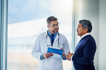 Image showing Consultation, medical and doctor talking to patient and writing notes on a clipboard for diagnosis in a clinic. Medicine, healthcare and professional man consulting person with health insurance