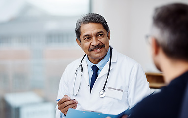 Image showing Healthcare, medical and doctor with a patient in a consultation in his office in the clinic. Professional, conversation and mature male phd worker consulting a man for diagnosis in medicare hospital.