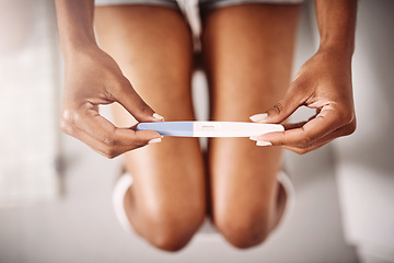 Image showing Hands, healthcare and closeup of a woman with a pregnancy test in the bathroom of her home. Maternity, motherhood and zoom of female person with pregnant stick device for announcement in modern house