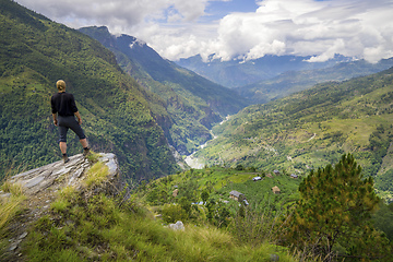 Image showing Man standing on hill top in Himalayas