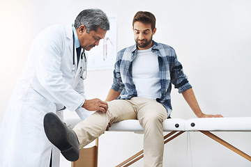 Image showing Healthcare, patient with knee pain and doctor at clinic, help and wellness checkup of person at hospital. Medicine, health care expert and Indian man in doctors office consulting medical professional