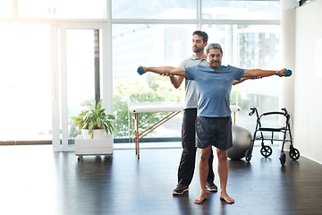 Image showing Training, physiotherapy and stretching with doctor and patient for rehabilitation, dumbbells and help. Healthcare, wellness and healing with old man and expert for consulting, muscle and exercise