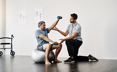Image showing Dumbbells, physiotherapy and rehabilitation with doctor and patient for help, training and stretching. Healthcare, wellness and healing with old man and expert for consulting, muscle and exercise
