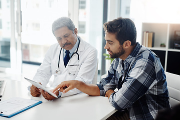 Image showing Healthcare, doctor and patient in consultation with tablet, expert advice, discussion and results. Medicine, health care and Indian man in doctors office, internet and consulting medical professional