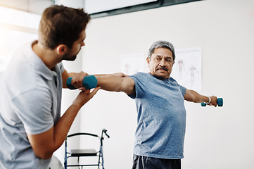 Image showing Dumbbells, physiotherapy and stretching with doctor and old man for rehabilitation, training and help. Healthcare, wellness and healing with patient and expert for consulting, muscle and exercise