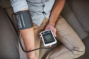 Image showing Hypertension, closeup and person with home test for blood pressure on living room sofa for medical or health exam. Monitor, reading and man with equipment for chronic disease or stress from top view