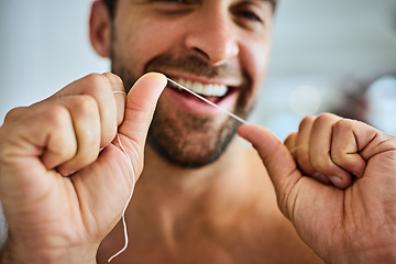 Image showing Hands, face and man floss teeth for smile, dental health and care for gum gingivitis at home. Closeup of happy guy, oral thread and cleaning mouth for fresh breath, tooth hygiene and healthy habit