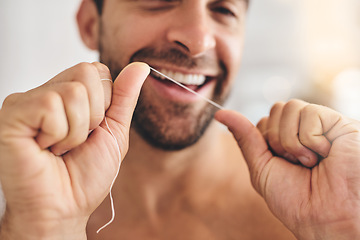 Image showing Hands, face and man flossing teeth at home for dental health, plaque and gingivitis on gums. Closeup of guy, oral thread and cleaning mouth for fresh breath, tooth hygiene and habit to care for smile