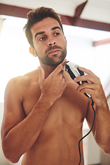 Image showing Man, shaving and face with electrical razor for hair removal, aesthetic skincare or beauty cleaning at home. Shirtless guy shave beard with blade, trimmer and cosmetic tool in bathroom in the morning