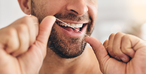 Image showing Closeup, face and man flossing teeth at home for healthy dental wellness, plaque and gingivitis. Happy guy, oral thread or cleaning mouth for fresh breath, tooth hygiene and habit to care for smile