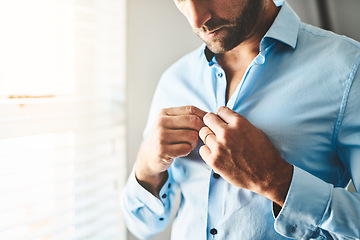 Image showing Hands, man and button shirt of clothes for job interview, work event and corporate fashion for business. Closeup, male person and ready in professional outfit from wardrobe in the morning at home