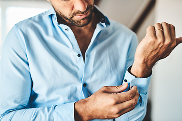 Image showing Closeup, man and button cuff of shirt for job interview, work and corporate fashion for business. Hands, arm and male person getting ready in professional clothes from wardrobe in the morning at home