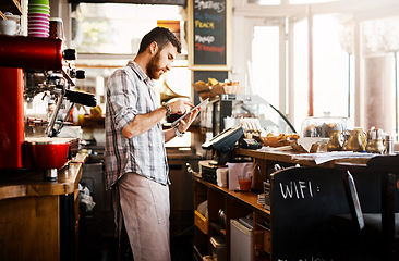 Image showing Digital tablet, research and cafe owner working on a startup cafeteria business plan in a restaurant. Technology, entrepreneur and male barista or waiter checking stock on a mobile in his coffee shop