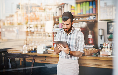 Image showing Tablet, business owner and man in a coffee shop doing inventory while working on a startup plan in a restaurant. Cafeteria, entrepreneur and male barista doing research on digital technology in cafe.