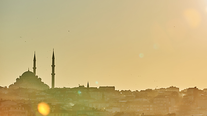 Image showing Silhouette of a Mosque Fatih in a fog and sunlight reflections. Vintage style.
