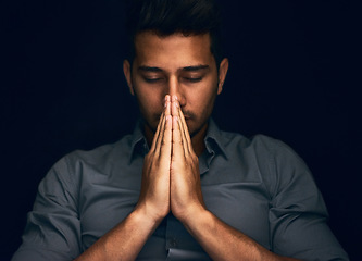 Image showing Night, worship and man with hands praying in studio to God, Jesus Christ or spiritual healing on black background. Holy, gratitude and thank you by christian male in prayer for help, hope and trust