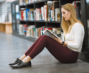 Image showing University, student and reading magazine in the library floor or free time studying or information and knowledge in college. Research, learning and scholar or analysing or book and academic journal