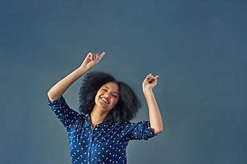 Image showing Portrait, happy and pointing with a woman advertising in studio on a blue background for branding. Smile, silly and hand gesture with a female brand ambassador showing blank or empty marketing space