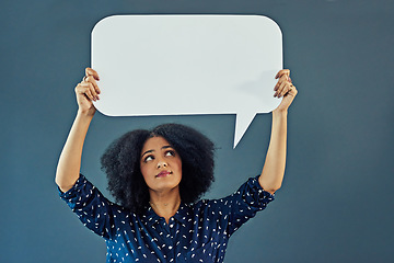 Image showing Mockup, speech bubble and woman in studio with banner for news, social media or advertising on blue background. Space, billboard and female person with paper, poster and branding promotion or launch