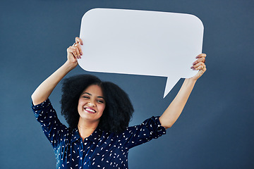 Image showing Portrait, speech bubble and woman in studio with banner, news or announcement on blue background. Mockup, poster and happy female face with billboard for social media, advertising or branding launch