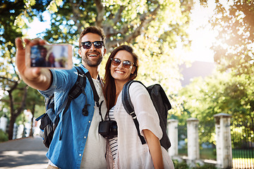 Image showing Selfie, happy couple and outdoor for travel with a smile for holiday memory and happiness. Man and woman at a park with trees for adventure, journey or vacation photo and freedom with love and care