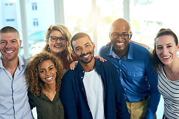 Image showing Business people, portrait and hug in a office with a smile from friends with teamwork and collaboration. Diversity, happiness and writer staff together and feeling proud from motivation and success