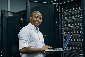 Image showing Server room, black man or portrait of technician with laptop for online cyber security glitch or software. IT support, happy or friendly African engineer fixing network for information technology