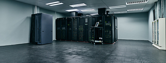 Image showing Server room, empty or data center for internet connection, computing network or cyber security hardware. IT support background, information technology or machine equipment with laptop in a datacenter