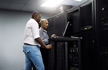 Image showing Server room, people or technician coding on computer together for a cybersecurity glitch with teamwork. IT support code, collaboration or engineers fixing laptop network for information technology