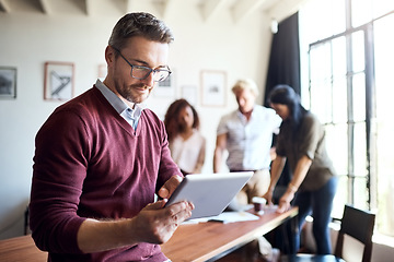 Image showing Man, tablet and working in office meeting with team in creative workspace and planning, research and management. Businessman, happy teamwork and web design leader with technology for project