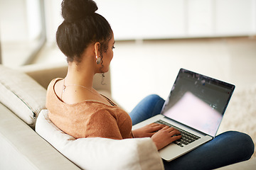 Image showing Woman on couch with laptop, typing for blog and freelance copywriter working from home. Female freelancer in living room, copywriting and writing on pc, technology and remote work with connectivity