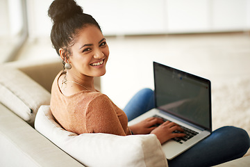 Image showing Happy woman in portrait, couch and laptop, typing for blog and freelance copywriter working from home. Female freelancer in living room, copywriting and writing on pc with technology and remote work