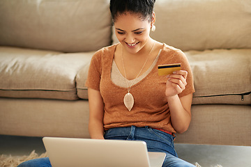 Image showing Woman in living room, laptop and credit card with online shopping and payment on store website with fintech. Female person at home, smile and happy with internet banking, finance and e commerce