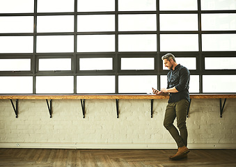 Image showing Phone, typing and man at office window with mockup, creative startup and project for entrepreneur at design agency. Networking, space and internet, businessman with online connectivity on smartphone.