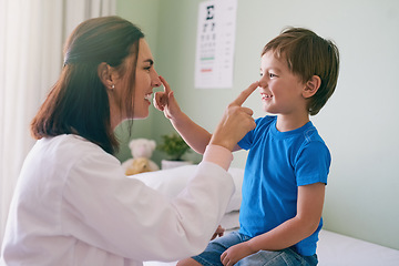 Image showing Woman doctor, playing and child fun at a hospital for healthcare and medical consultation. Smile, trust and pediatrician touch nose with a laugh and happiness in a clinic with boy patient with exam