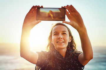 Image showing Selfie, nature and woman with smart phone or enjoying ocean or relaxed face for vacation in summer or excited on bokeh. Face, female person and taking picture or holiday fun or blue sky and sea