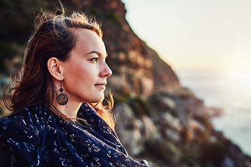 Image showing Beach, woman and enjoying sunset outdoors or relaxed for vacation in summer or thinking in nature and on bokeh. Face, view and female person on break or mindfulness for scenic travel on holiday