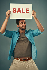 Image showing Happy man, sale and billboard poster for advertising, marketing or branding against a grey studio background. Male person or realtor holding board or sign for sales announcement or advertisement