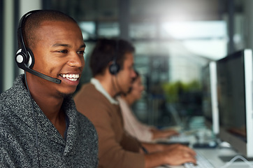 Image showing Call center, customer service and male consultant in office doing online consultation. Communication, contact us and salesman or telemarketing agent working on crm strategy with headset in workplace.