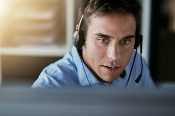 Image showing Telemarketing agent, focus and man consulting with advice, sales or help desk worker with headset. Phone call, conversation and customer support consultant, crm service agency listening on headphones