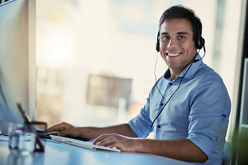 Image showing Portrait of callcenter agent, smile and man consulting with advice, crm and happiness at help desk. Phone call service, conversation and happy customer support consultant working in modern office.